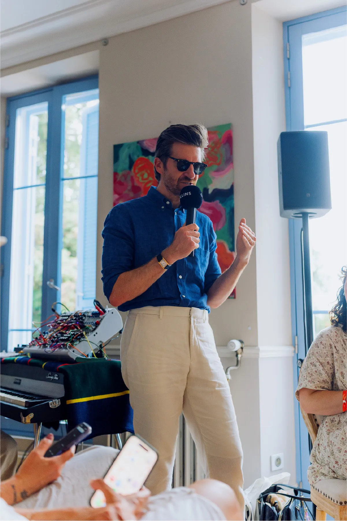James Nord speaking to a room at Cannes, microphone in hand